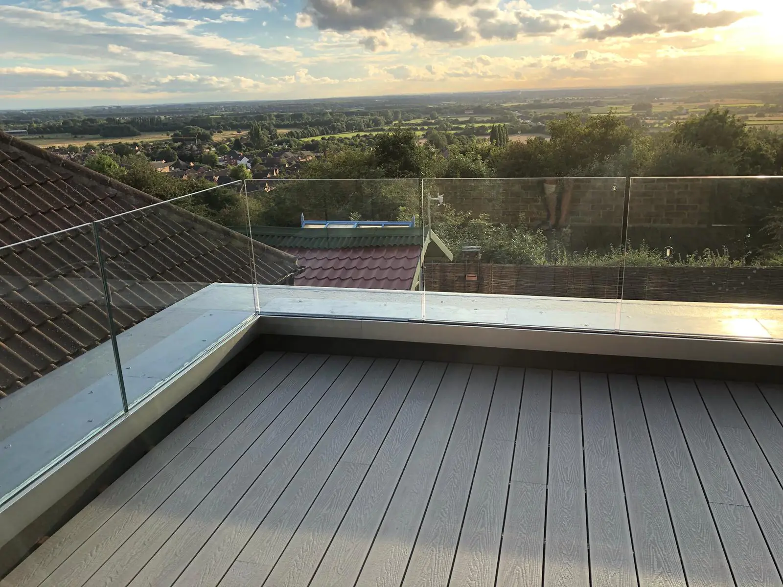 Moder Grey Decking With Balustrade In Sunset